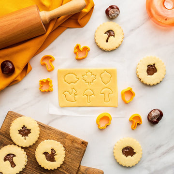 Set of six mini 3D autumn leaf cookie stamps that cut and emboss in one press, with the cookies they make
