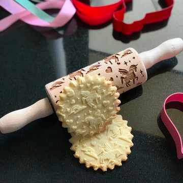 Unicorn pattern on a small wooden embossed rolling pin for children, with the cookies it prints