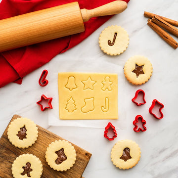 Set of six mini 3D Christmas cookie stamps that cut and emboss in one press, with the cookies they make