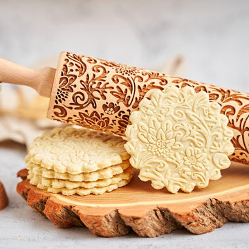 Garden Of Paradise pattern engraved on a wooden embossed rolling pin, beside the cookies it prints